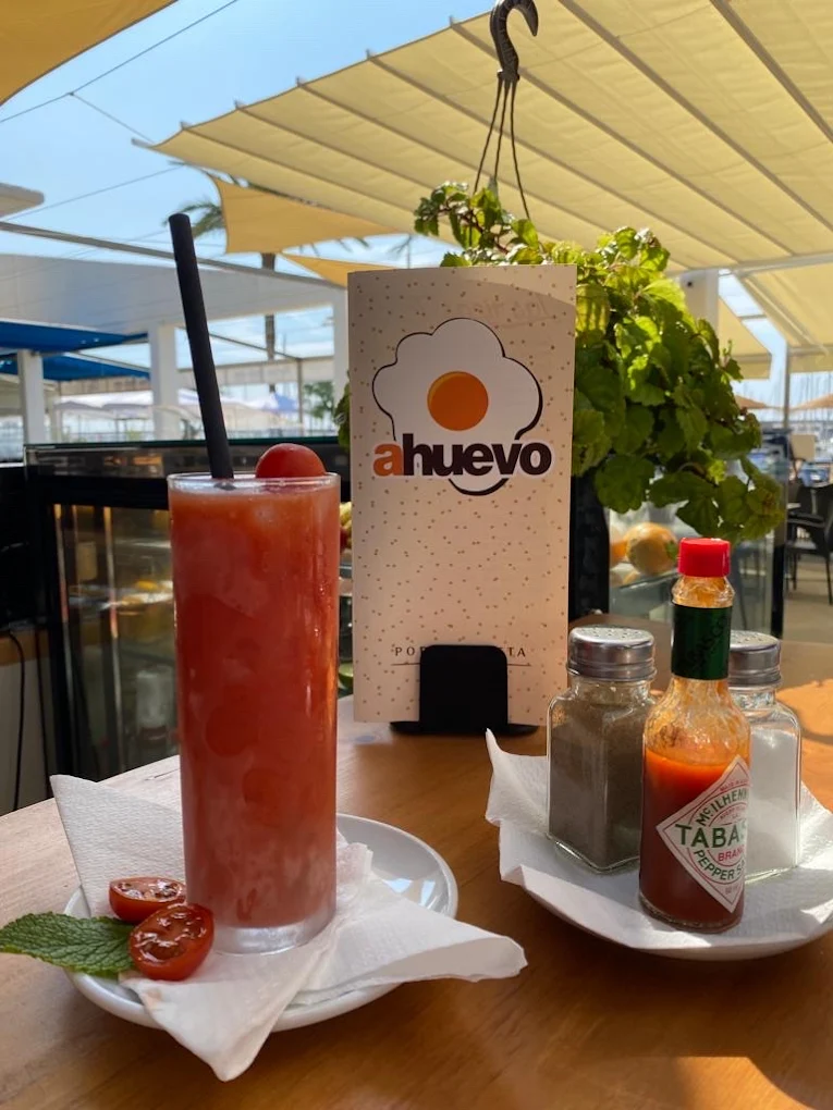Bebida en la terraza con barcos al fondo